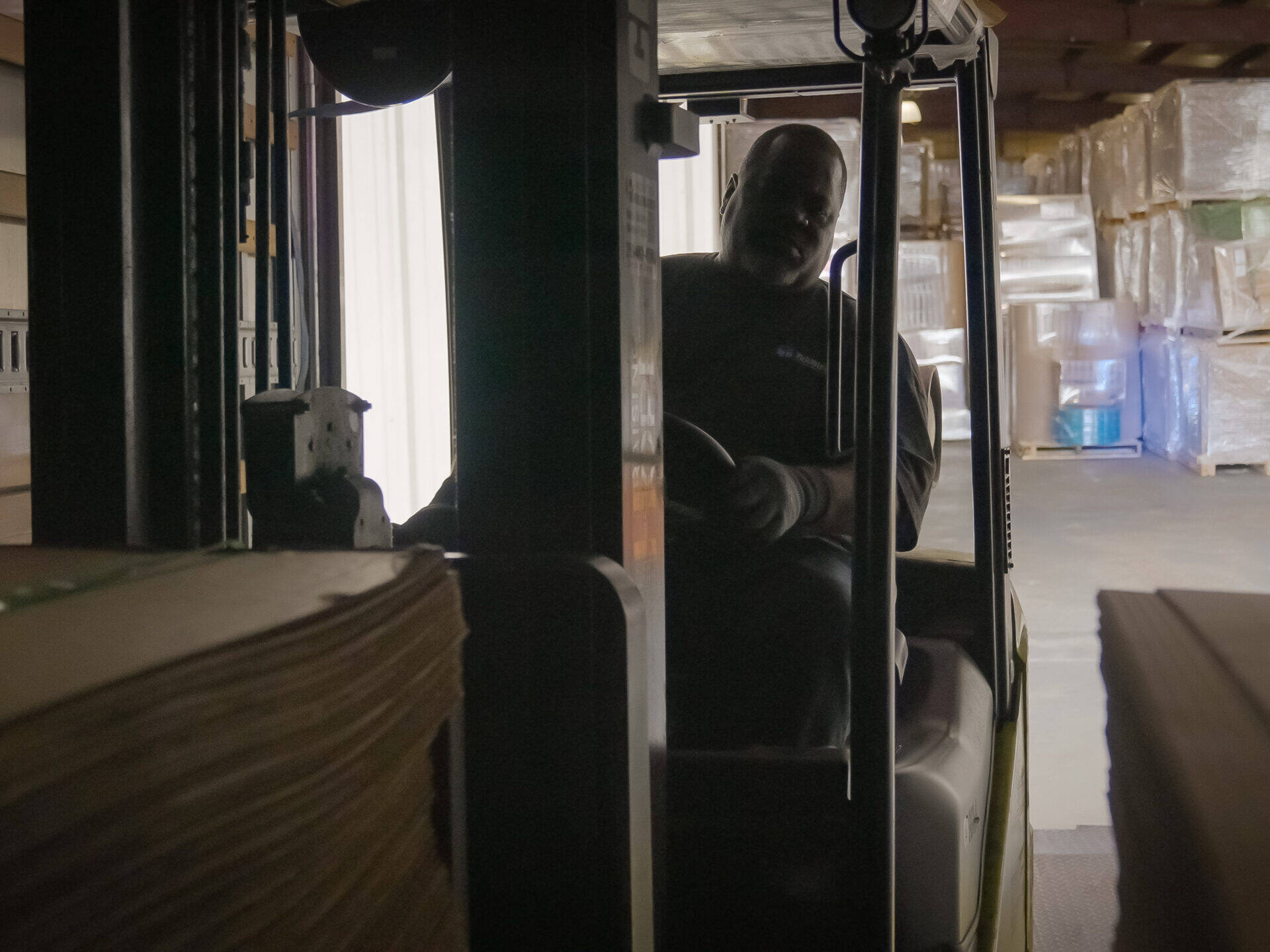 warehouse worker driving forklift